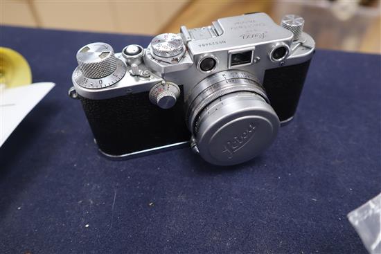 A Leica DRP Ernst Leitz Wetzlar 35mm camera No. 529484, Elmar 1 : 4/135 telephoto lens No.1882960 and sundry Leica accessories,